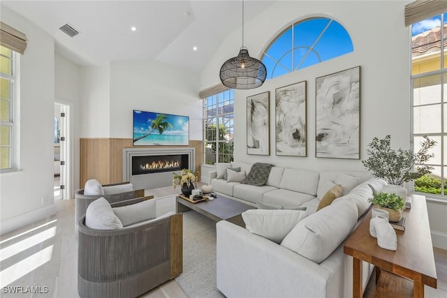 living room with high vaulted ceiling