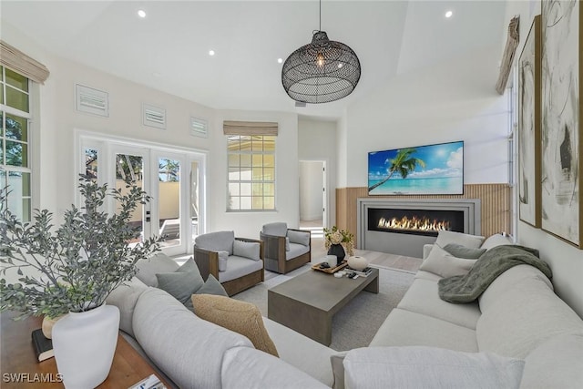 living room with french doors and a high ceiling