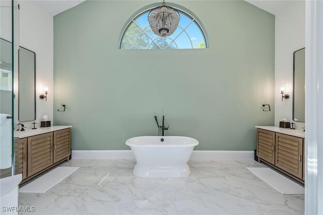 bathroom featuring a tub, a towering ceiling, and vanity