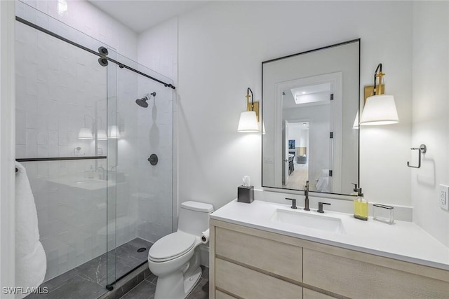 bathroom with an enclosed shower, vanity, and toilet