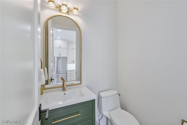 bathroom featuring toilet and vanity