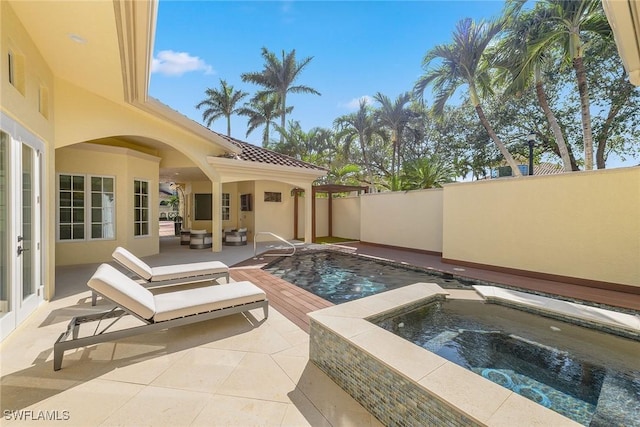 view of pool with a patio area, outdoor lounge area, and an in ground hot tub