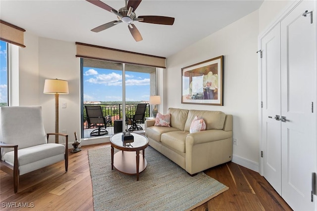 living room featuring ceiling fan and wood-type flooring