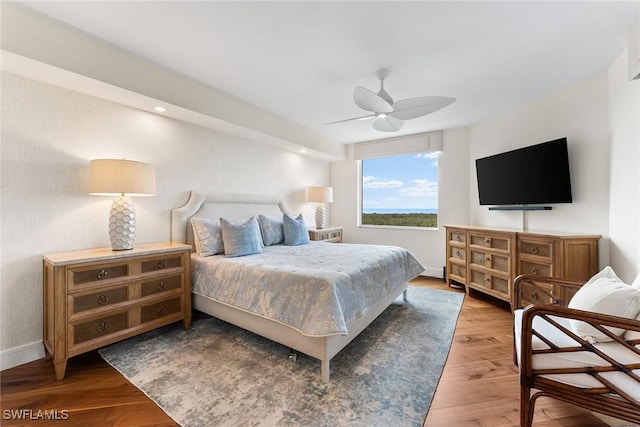 bedroom with ceiling fan and dark wood-type flooring