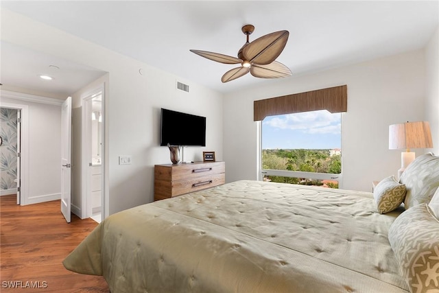 bedroom with ceiling fan and hardwood / wood-style flooring