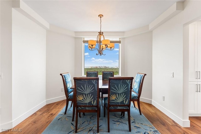 dining area with an inviting chandelier and hardwood / wood-style floors