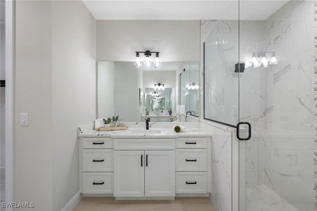 bathroom featuring an enclosed shower and vanity