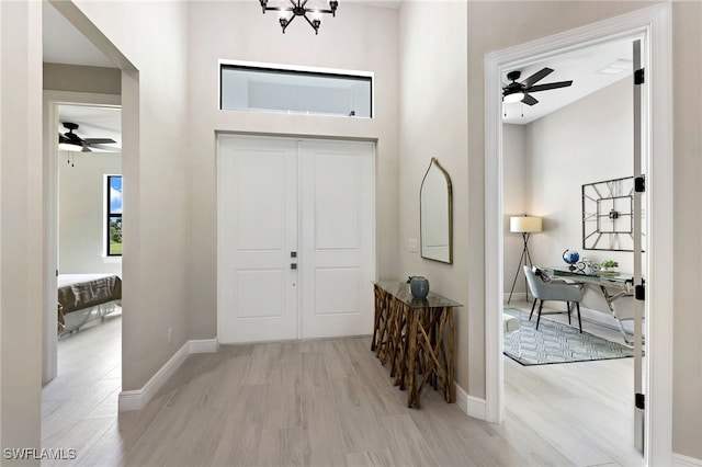 entryway with ceiling fan and light hardwood / wood-style floors