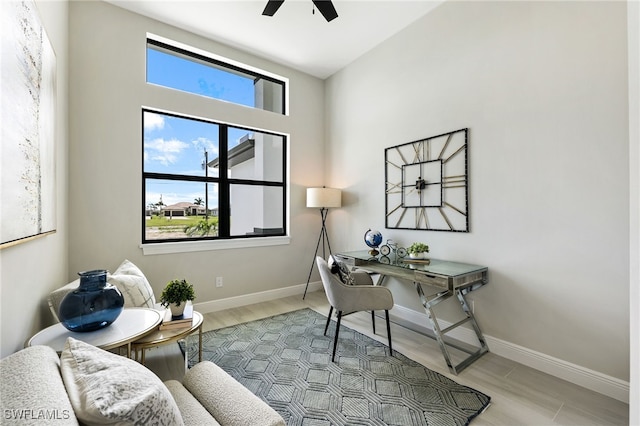 office area with ceiling fan, plenty of natural light, and light hardwood / wood-style floors