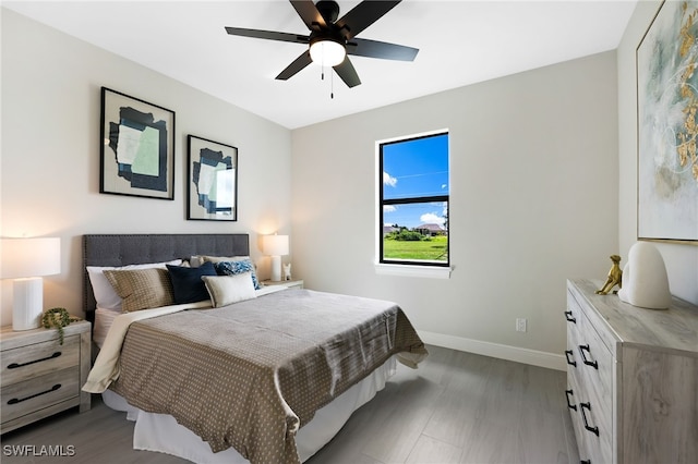 bedroom with hardwood / wood-style flooring and ceiling fan