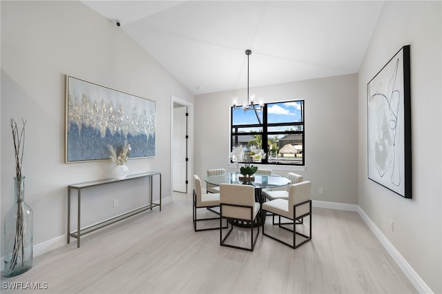 dining room featuring an inviting chandelier, vaulted ceiling, and light hardwood / wood-style flooring