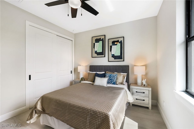 bedroom with hardwood / wood-style flooring, ceiling fan, and a closet