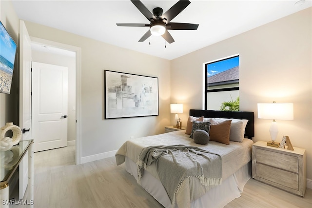 bedroom with ceiling fan and light hardwood / wood-style floors