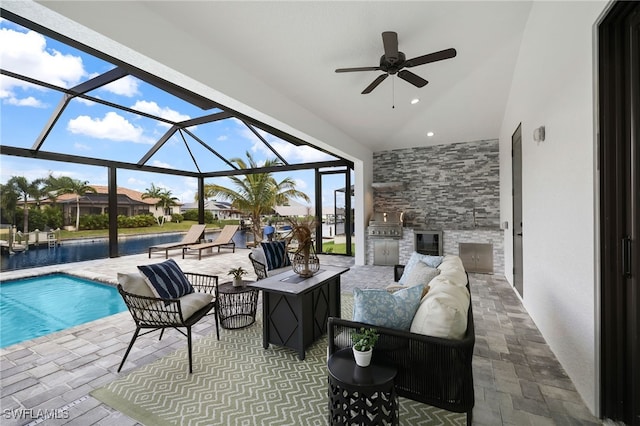 view of patio / terrace with area for grilling, ceiling fan, an outdoor hangout area, and glass enclosure