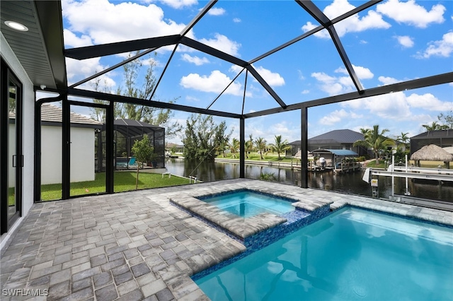 view of swimming pool featuring glass enclosure, an in ground hot tub, and a water view