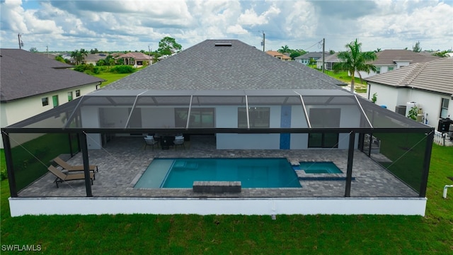 back of property with a pool with hot tub, a patio, and a lanai