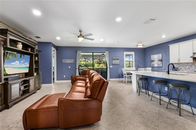 living room featuring sink and ceiling fan