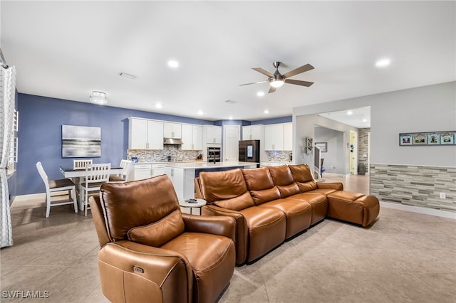 living room featuring ceiling fan and light tile patterned floors