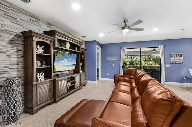 home theater with ceiling fan and wooden walls