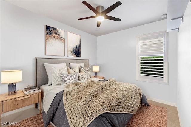 bedroom with ceiling fan and light tile patterned flooring