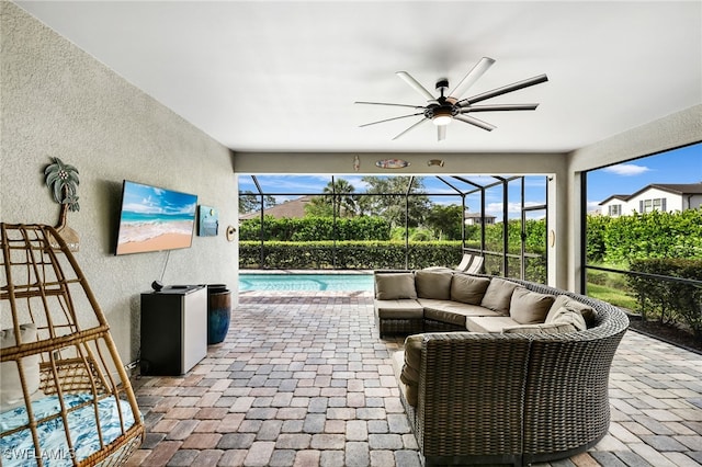 view of patio featuring an outdoor living space, ceiling fan, and a lanai