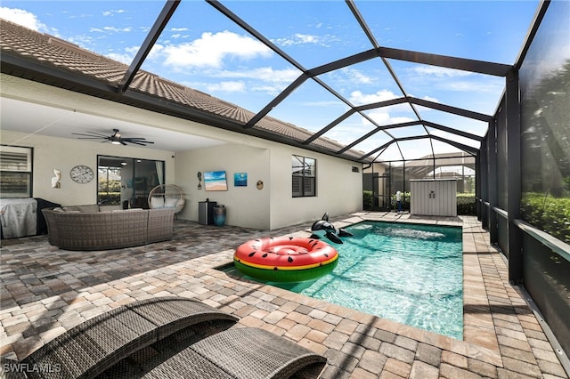 view of swimming pool with ceiling fan, a patio area, a lanai, and an outdoor hangout area