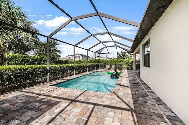 view of swimming pool with a patio and a lanai