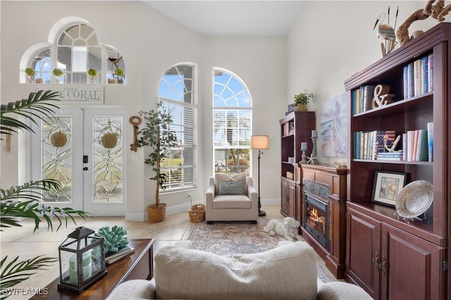 sitting room with light tile patterned floors and french doors