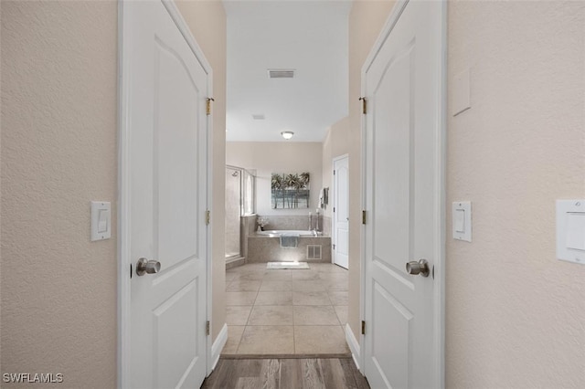 hall with light hardwood / wood-style flooring