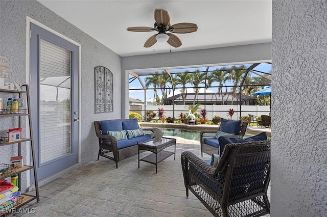 sunroom / solarium featuring ceiling fan