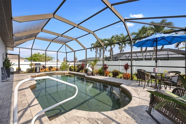 view of swimming pool with a patio and a lanai