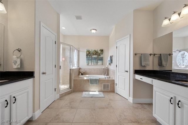 bathroom featuring vanity, tile patterned floors, and plus walk in shower