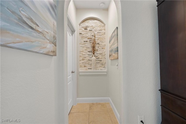 corridor with light tile patterned flooring