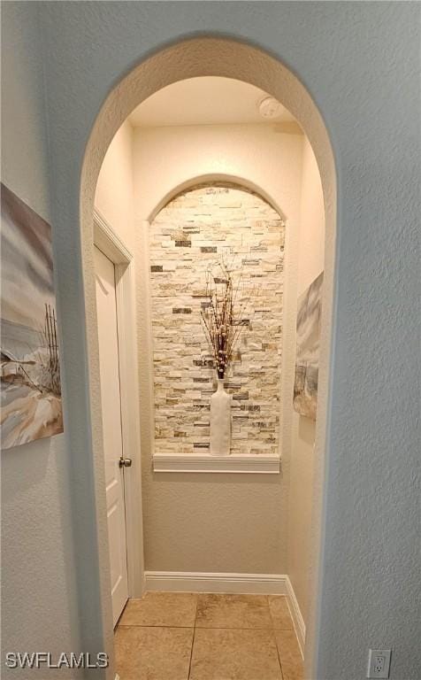 hall featuring light tile patterned flooring