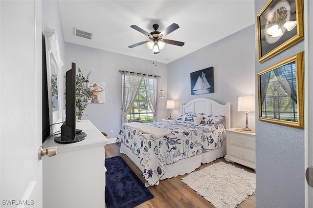 bedroom with wood-type flooring and ceiling fan