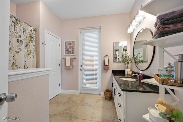 bathroom featuring a shower with curtain, vanity, and tile patterned flooring