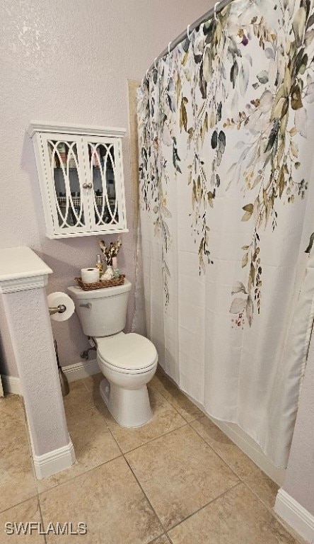 bathroom with tile patterned flooring and toilet