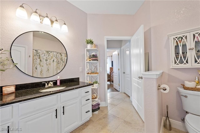 bathroom with tile patterned floors, vanity, and toilet