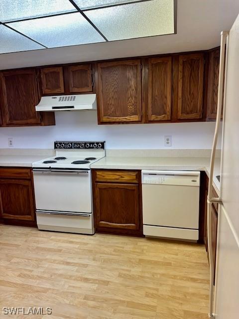 kitchen featuring white appliances and light wood-type flooring