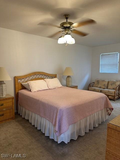 bedroom with ceiling fan and dark carpet