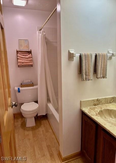 full bathroom with vanity, wood-type flooring, toilet, and shower / tub combo with curtain