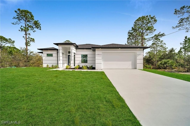 view of front of home featuring a front lawn and a garage