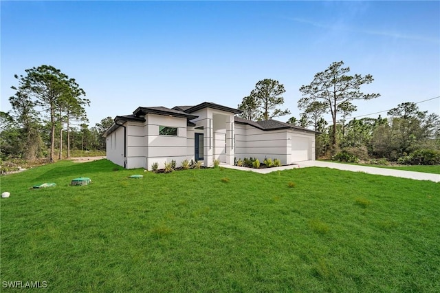 view of front of property with a garage and a front lawn