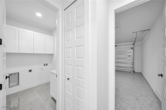 clothes washing area with hookup for an electric dryer, hookup for a washing machine, and cabinets