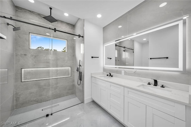 bathroom with vanity and a shower with door