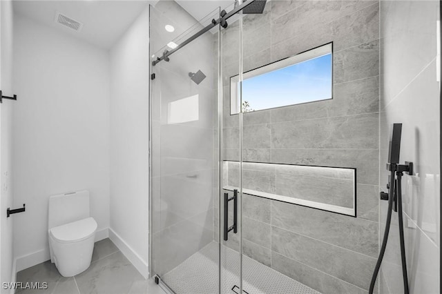 bathroom with walk in shower and toilet