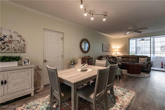 dining area featuring crown molding, ceiling fan, and dark hardwood / wood-style flooring