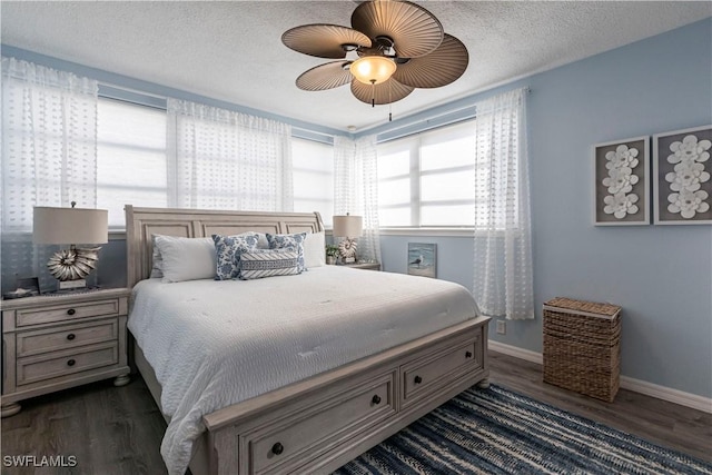 bedroom with dark wood-type flooring, ceiling fan, and a textured ceiling