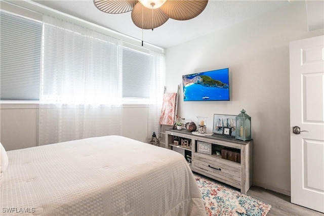 bedroom with ceiling fan and light hardwood / wood-style flooring