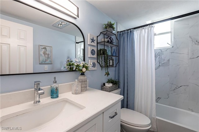 full bathroom with vanity, shower / tub combo, and toilet